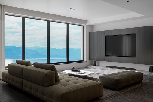 Interior of a contemporary luxury living room with beautiful mountain and ocean view.