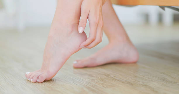 istock girl scratching her heel 1421744631