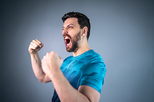 Male athlete / fan celebrating on blue uniform