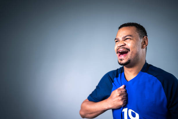 Male athlete / fan celebrating on blue uniform