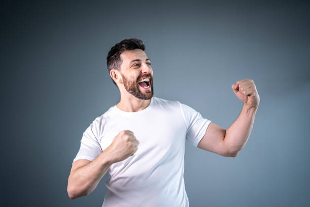 istock Male athlete / fan celebrating on white uniform 1421748719