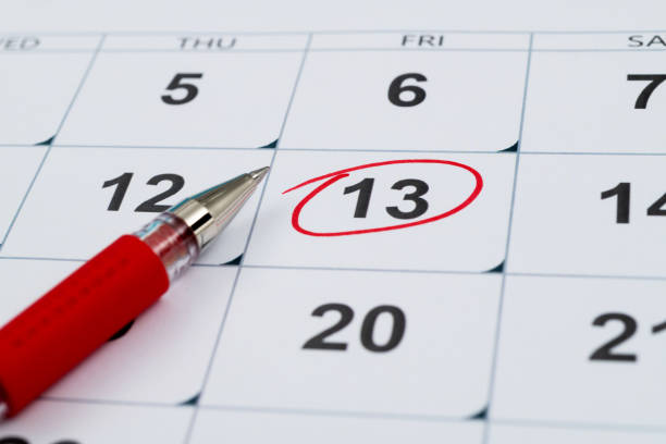 Red mark on the calendar at number 13 stock photo