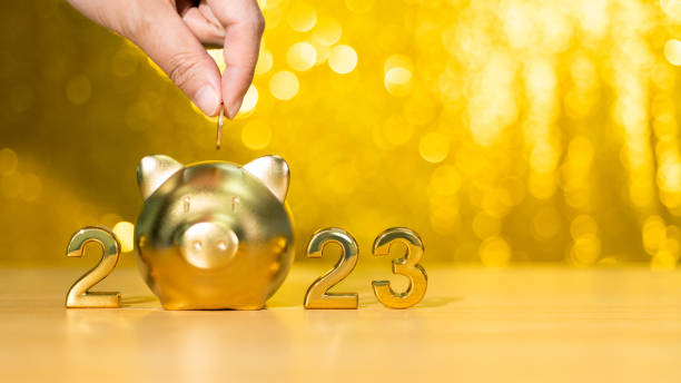 2023 new year and piggy bank on the table stock photo