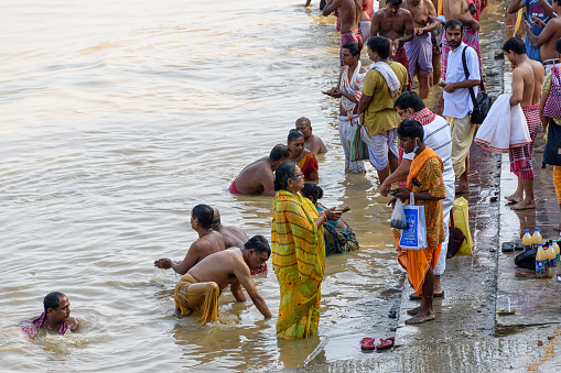 Indian Hindu people faithfully performed Tarpan on the bank of the holy river Ganges at Mahalaya Pitru Paksha. Kolkata, West Bengal, India on October 06, 2021