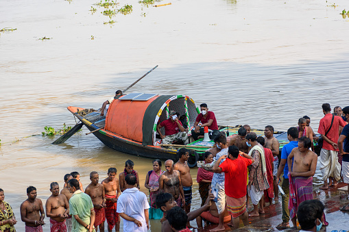 Indian Hindu people faithfully performed Tarpan on the bank of the holy river Ganges at Mahalaya Pitru Paksha. Kolkata, West Bengal, India on October 06, 2021