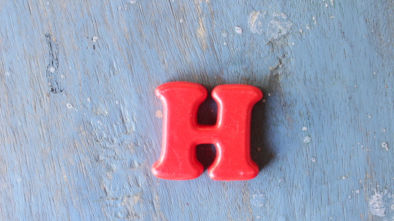 Close-up of three-dimensional grind coffee bean alphabet letter E on white background.