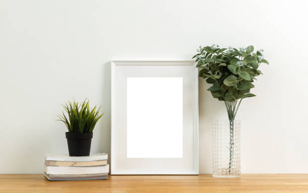 istock Style picture frame still life put on the wooden table. Blank space empty picture frame with mockup. Shot in studio with natural light. Template background interior design and decoration. 1421757239