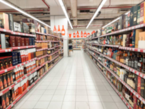 Blurry photo. Alkaid drinks on supermarket shelves. Without people. Background image. Blurry photo. Alkaid drinks on supermarket shelves. Without people. Background image. rose champagne stock pictures, royalty-free photos & images
