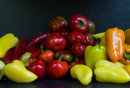 red and green bell peppers and red chili peppers in a group close-up for wallpaper desktop background