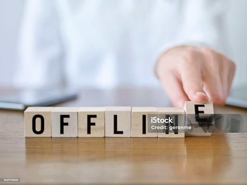 Offline Businesswoman forming ‘Offline’ text with cubic blocks Offline - Technology Stock Photo