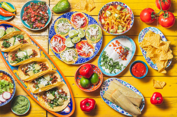 독립 기념일 무의존성을위한 멕시코 축제 음식 - 칠레 엔 노가다, 타코 알 목사, chalupas pozole, 타말레, 두더지 포블라노 소스를 곁들인 닭고기. 노란색 배경. - mexican dish 뉴스 사진 이미지