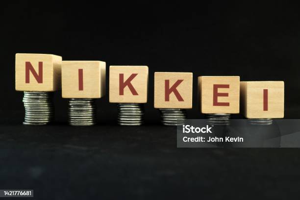 Japanese Nikkei Stock Market Index Crash And Bear Market Due To Financial Crisis And Recession In Japan Wooden Blocks In With Coins In Dark Black Background Stock Photo - Download Image Now