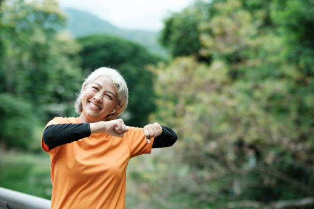 istock Happy athletic Senior woman in park. 1421779973