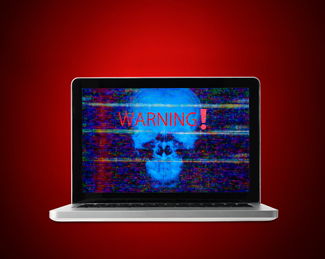 Laptop with warning skull on red background.
Information security concepts.