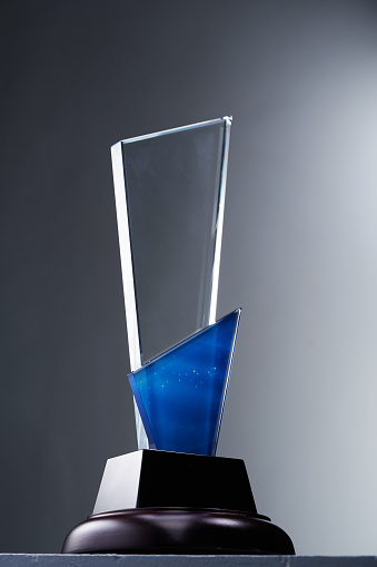 glass trophy against gray background