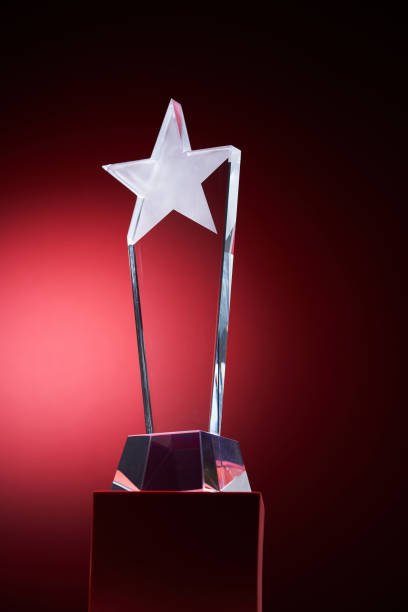 istock crystal trophy with star shape design against red background 1421786051