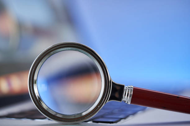 istock Laptop with magnifying glass as a symbol for searching information on the internet. 1421786272