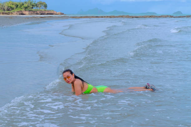 istock Woman with swimsuit  relax at beach Hat Wanakon 1421790458