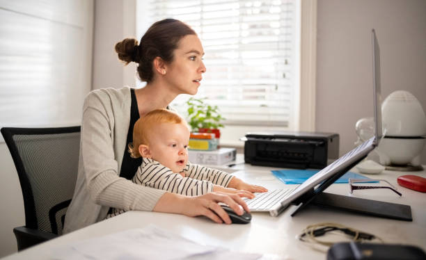 istock Woman with son working on laptop at home 1421792916