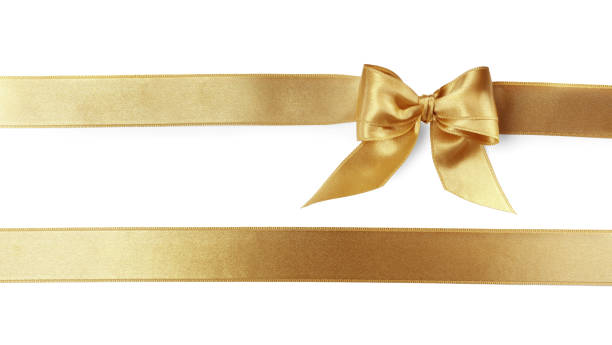 istock Beautiful golden ribbons with bow on white background, top view 1421796990
