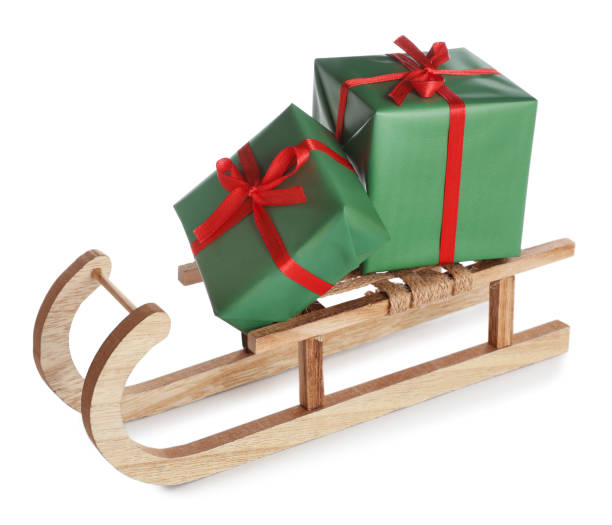 istock Wooden sleigh with Christmas gift boxes on white background 1421797284