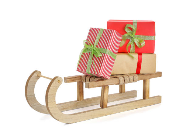 istock Wooden sleigh with Christmas gift boxes on white background 1421797879