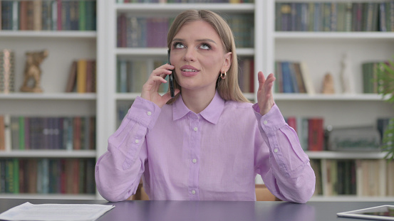 Young Woman Talking on Phone in Office