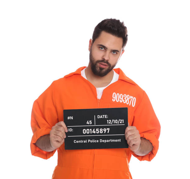istock Prisoner with mugshot letter board on white background 1421800770