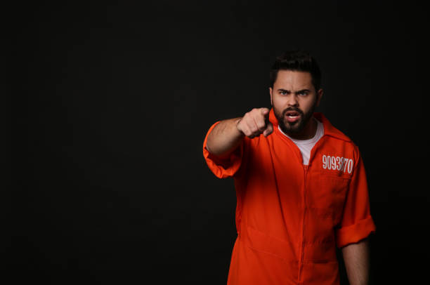 istock Prisoner in jumpsuit on black background, space for text 1421801179