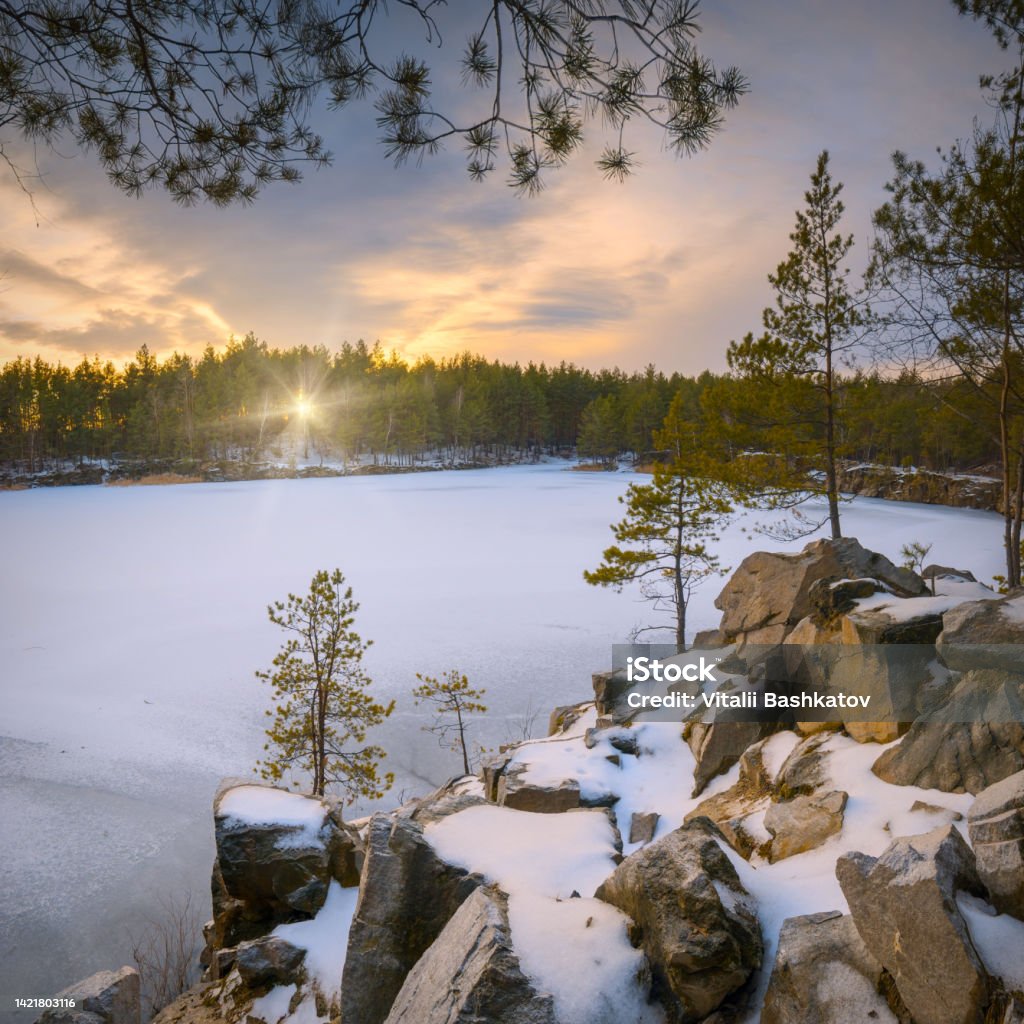 Frosen winter lake Sunset on a frosen winter lake in a forest Romance Stock Photo