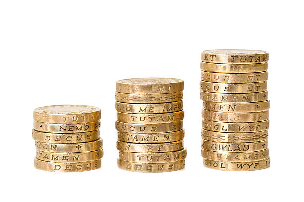 Picture of three piles of British pound coins Three piles of one pound British coins one pound coin stock pictures, royalty-free photos & images