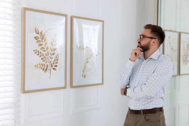istock Thoughtful young man at exhibition in art gallery 1421809720