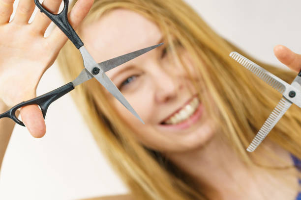 istock Girl with scissors for haircutting 1421812278
