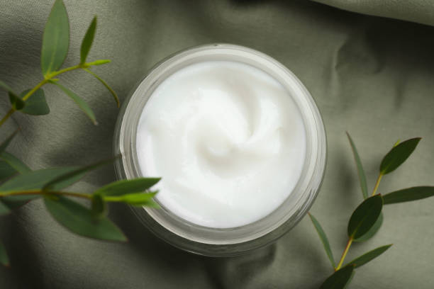 istock Jar of organic cream and eucalyptus on fabric, top view 1421812454