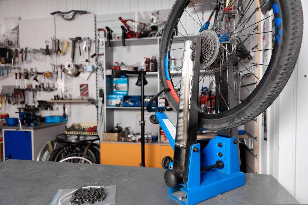 istock Against background of wall with tools close-up is a blue bicycle wheel holder 1421815224