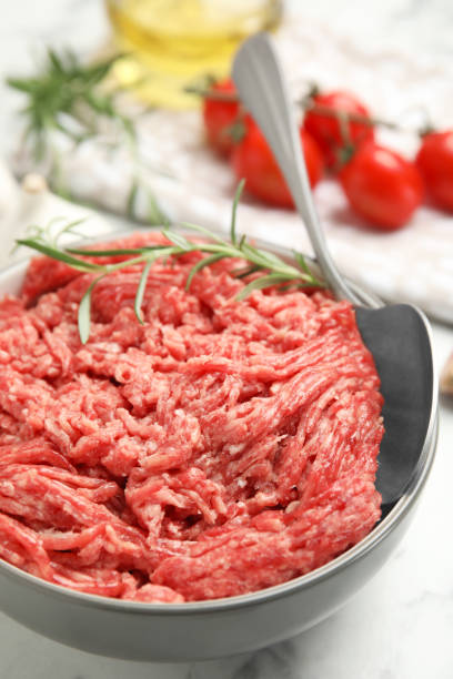 istock Fresh minced meat in ceramic on white marble table, closeup 1421818683