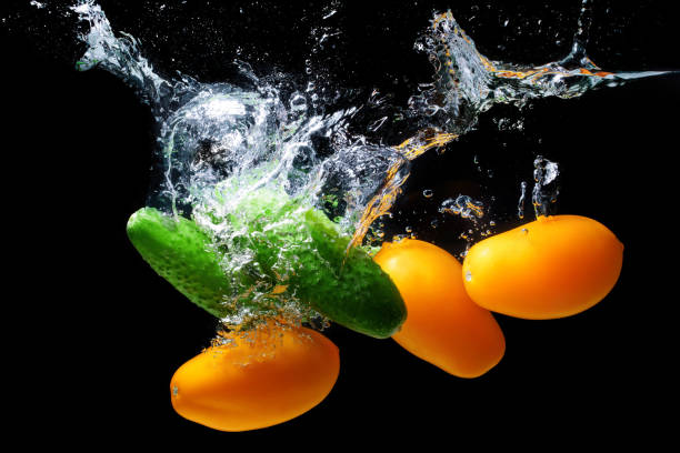 istock Cucumbers and plum tomatoes dropped in water 1421820381