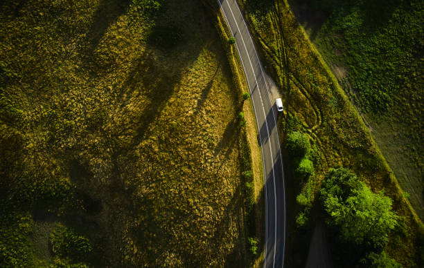 istock Country road through landscape 1421820812