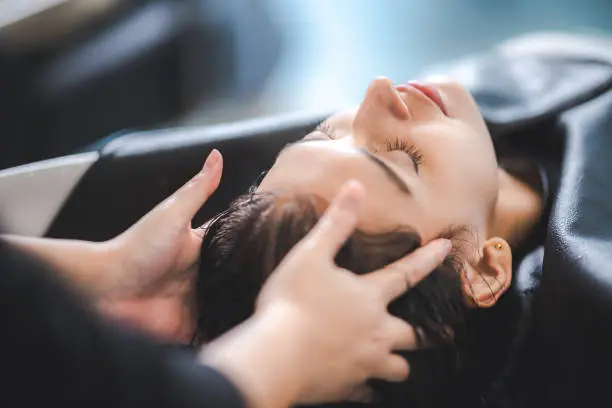 hairdresser washing client's hair at salon. happy young women customer relax and comfortable while washing hair, luxury hair spa by professional hairstylist