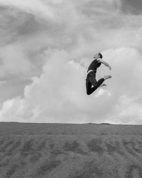 istock Man jumping above sand desert 1421821172