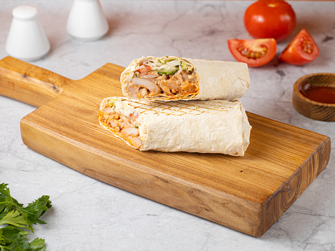 Delicious shawarma sandwich on wooden background. Banner.