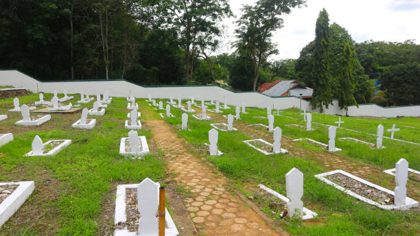 a public cemetery complex or graveyard with white cement walls and green grass for the dead stock photo