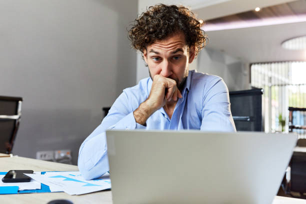 istock Worried businessman working on a computer in the office. 1421829315