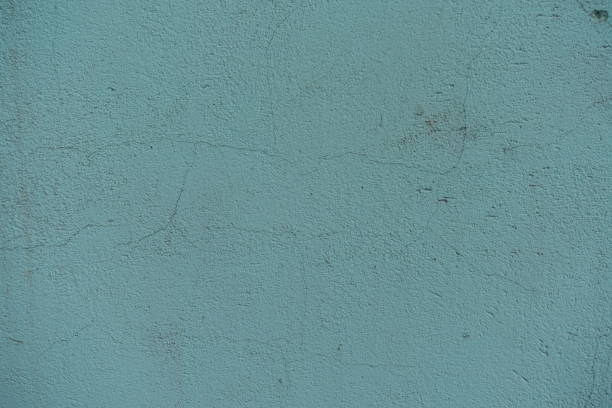 istock Surface of old dusty mint colored painted wall with cracks 1421830366