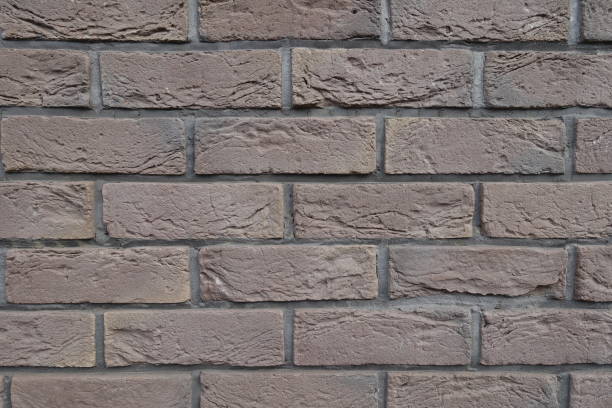 istock Uneven surface of dark chocolate brown brick wall 1421830702