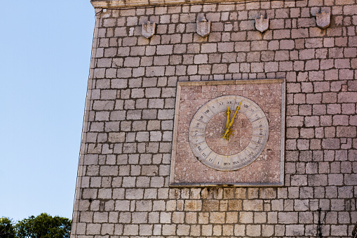 Unusual sundial clock on an old building