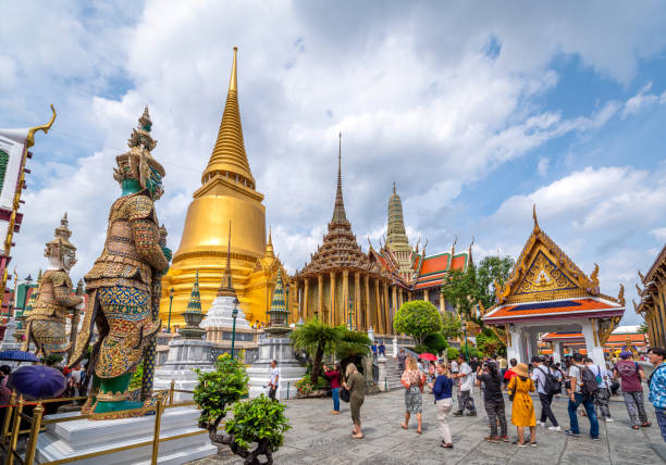 Bangkok, Thailand - September 9, 2019: tourists visitin the Grand Palace Wat Phra Kaew Ancient temple in bangkok on the beautiful cloudy blue sky