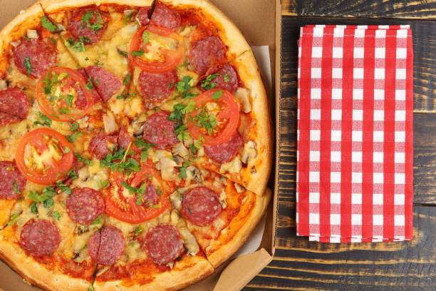 istock pizza in box open. Pizza in the in delivery box 1421848331