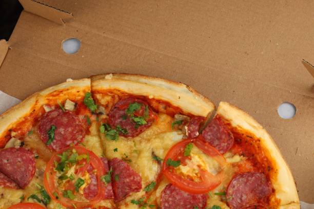 istock pizza in box open. Pizza in the in delivery box 1421848613