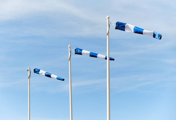 Wind sign against a cloudy blue sky